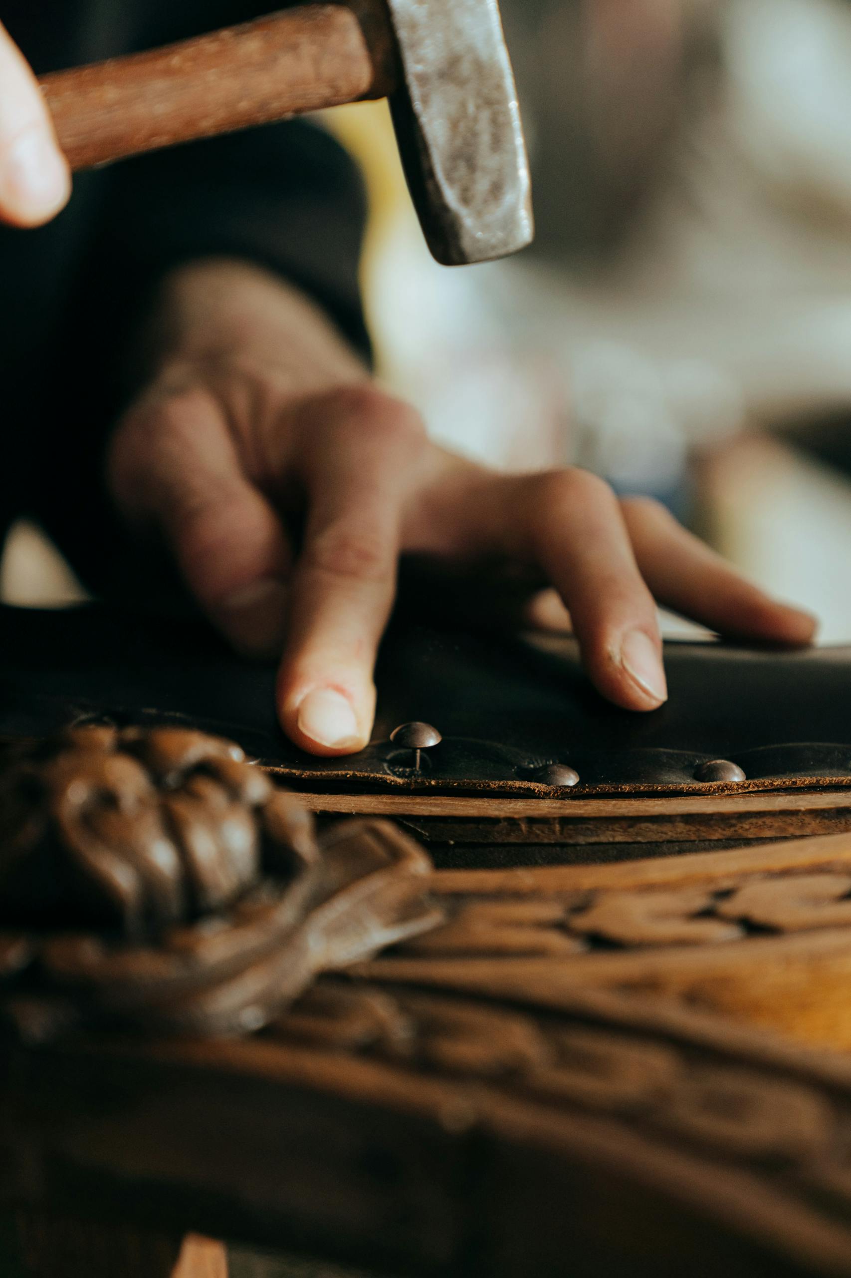 Persons Hand on Brown Wooden Table